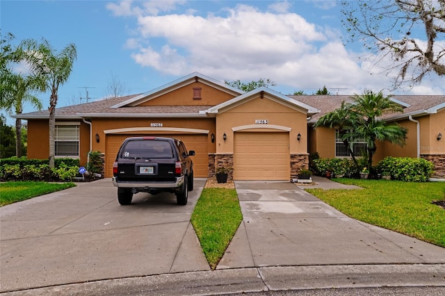 single story home featuring a front yard and a garage