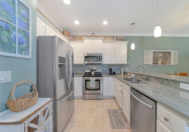 kitchen with white cabinetry, hanging light fixtures, appliances with stainless steel finishes, sink, and light tile floors