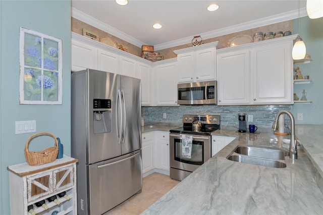 kitchen featuring sink, light stone counters, hanging light fixtures, white cabinets, and appliances with stainless steel finishes