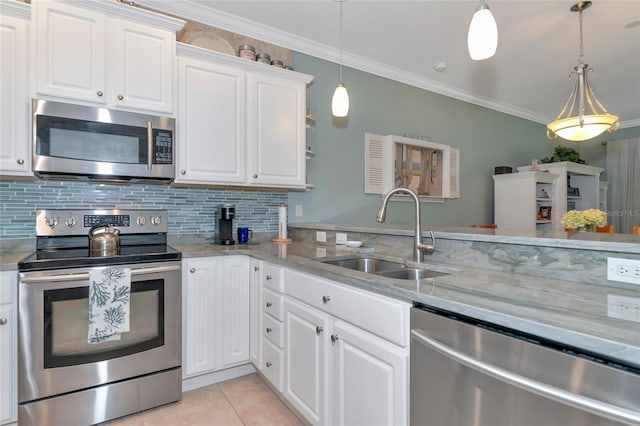 kitchen with light stone countertops, decorative light fixtures, white cabinetry, sink, and stainless steel appliances