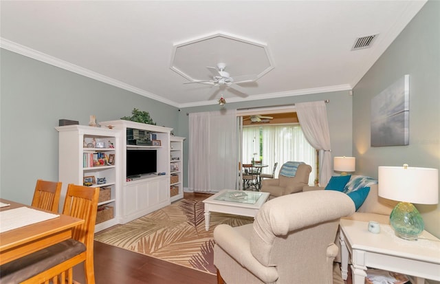 living room with light hardwood / wood-style floors, ceiling fan, and ornamental molding