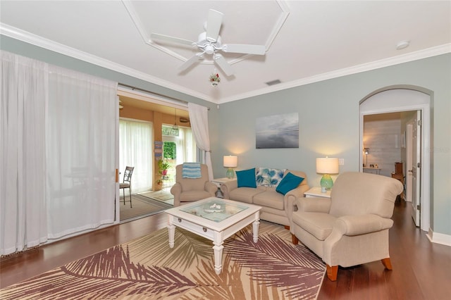 living room with ornamental molding, ceiling fan, and dark hardwood / wood-style flooring