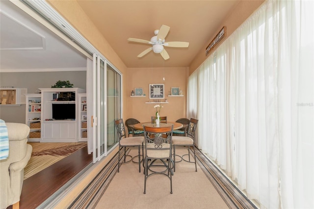 sunroom / solarium featuring ceiling fan