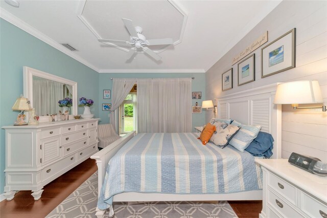 bedroom featuring ornamental molding, ceiling fan, and dark hardwood / wood-style flooring