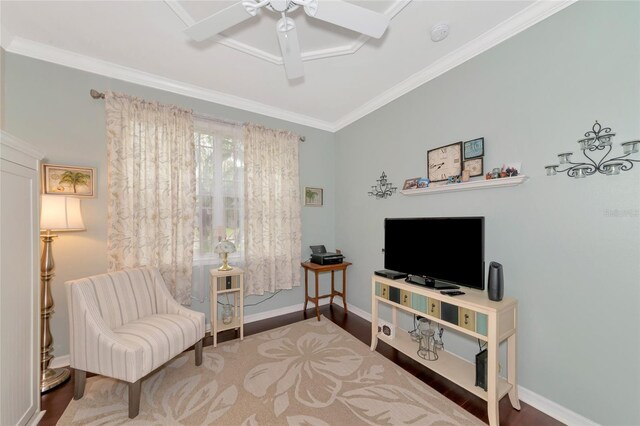 sitting room with dark wood-type flooring, ceiling fan, and crown molding