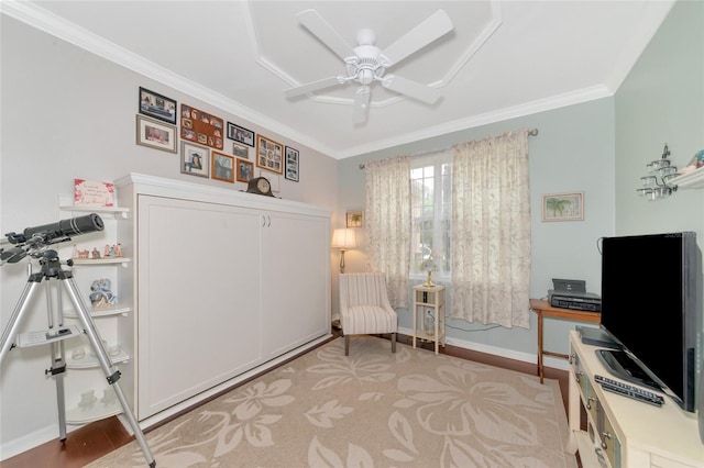 sitting room featuring ceiling fan and crown molding