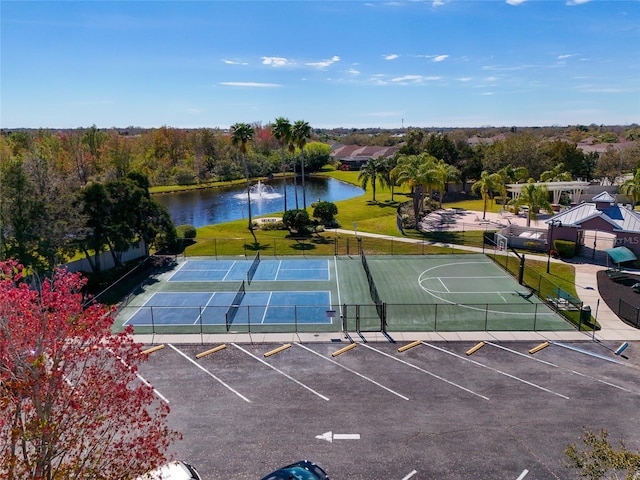 view of tennis court with a water view