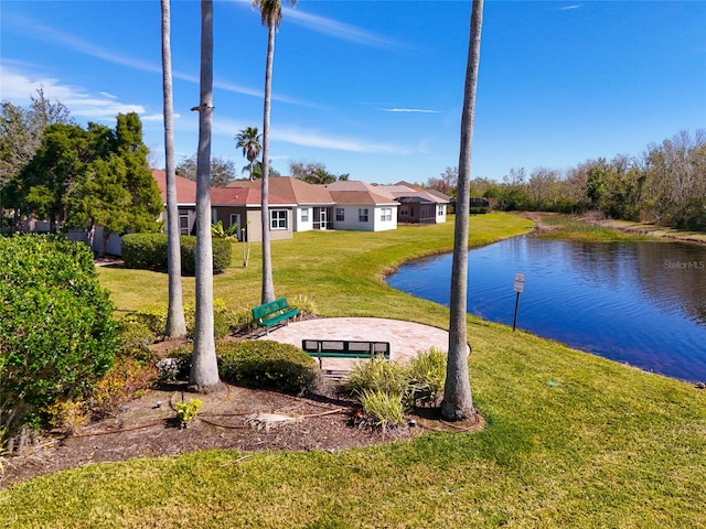 view of nearby features featuring a lawn, a patio area, and a water view