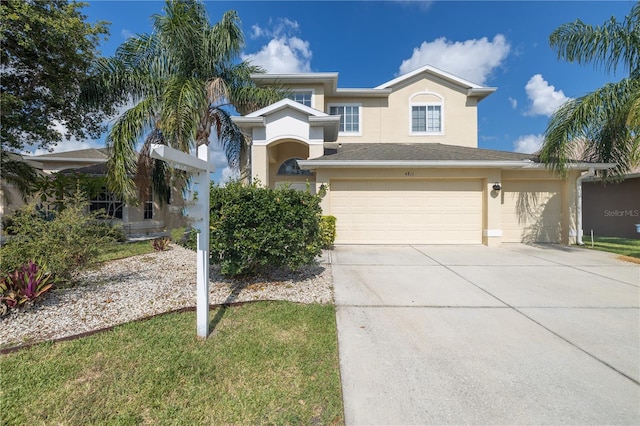 view of front of home with a front lawn and a garage