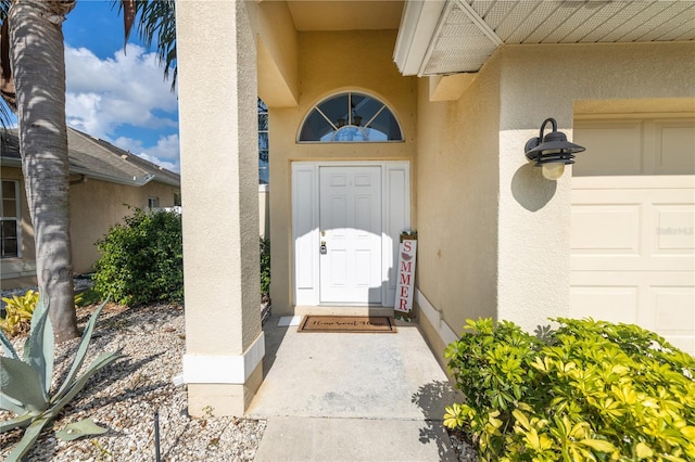 view of exterior entry featuring a garage