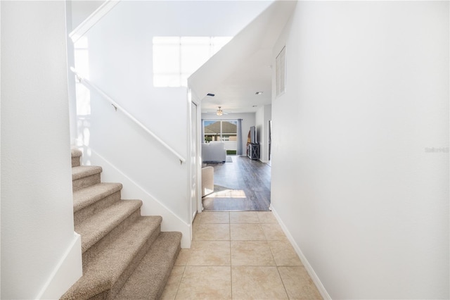 hallway featuring light tile floors