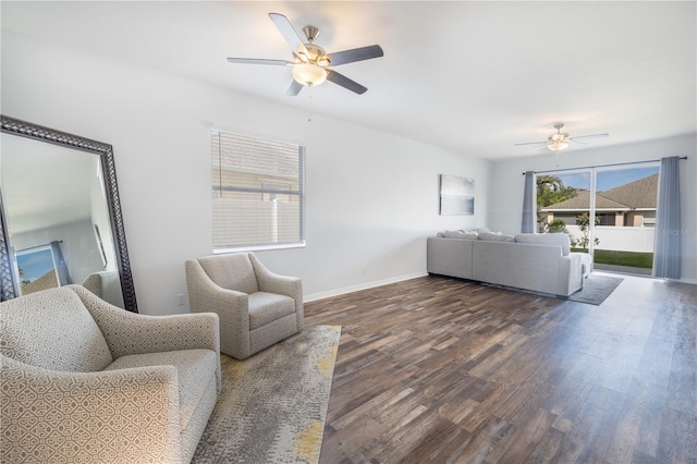 living room featuring dark hardwood / wood-style floors and ceiling fan