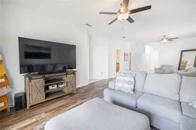 living room featuring ceiling fan and hardwood / wood-style flooring