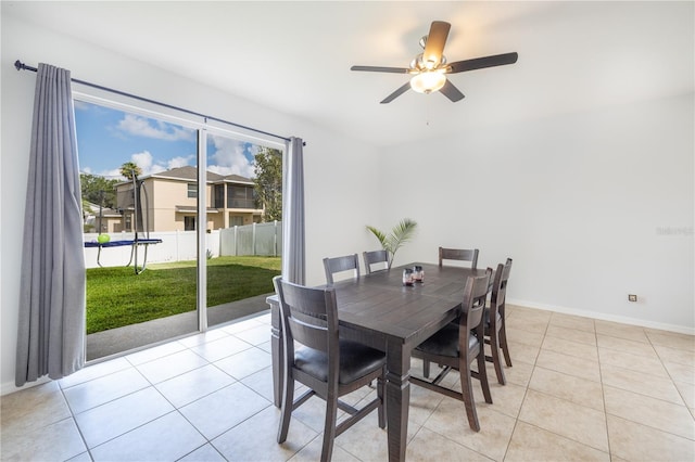 dining area featuring light tile floors and ceiling fan