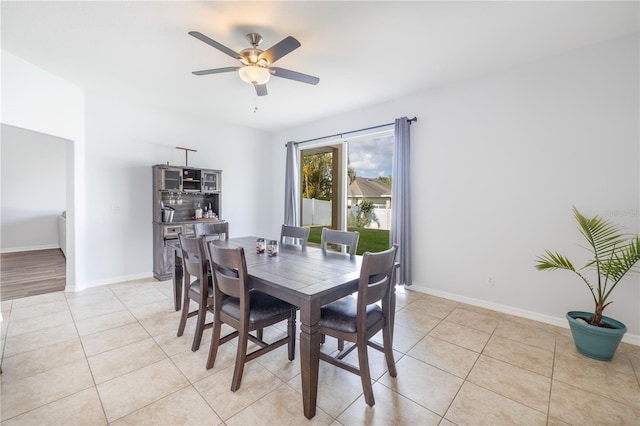 tiled dining space featuring ceiling fan