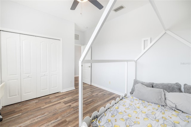 bedroom featuring vaulted ceiling, a closet, ceiling fan, and dark hardwood / wood-style floors