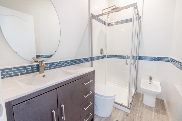 bathroom with toilet, a bidet, vanity, tasteful backsplash, and an enclosed shower