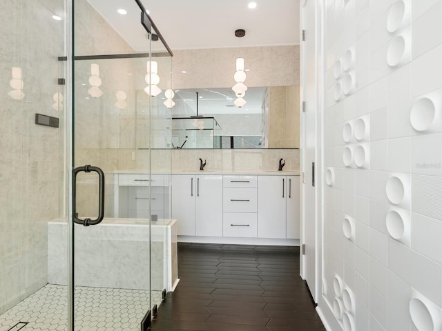 bathroom featuring vanity, tile walls, and an enclosed shower