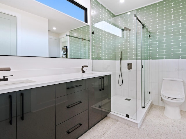 bathroom featuring tile walls, vanity, toilet, and an enclosed shower