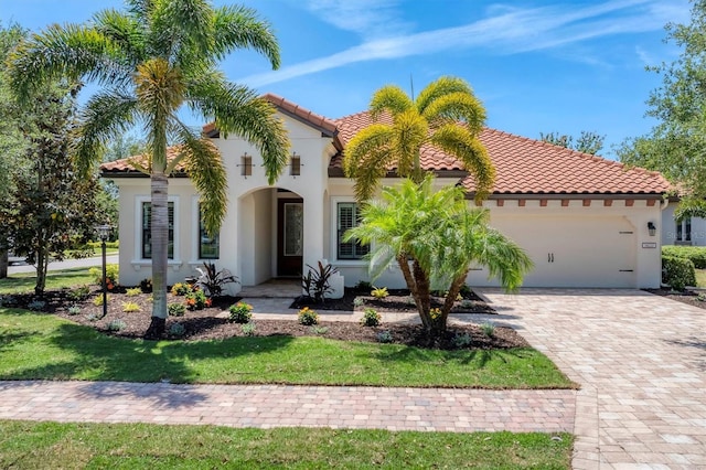 mediterranean / spanish-style home with a front yard and a garage