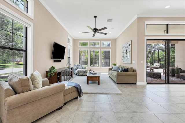 living room featuring ceiling fan, ornamental molding, and light tile flooring