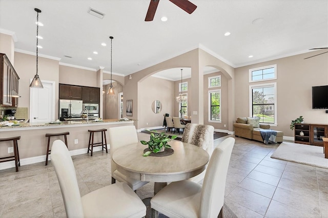 dining area featuring ceiling fan, crown molding, and light tile floors