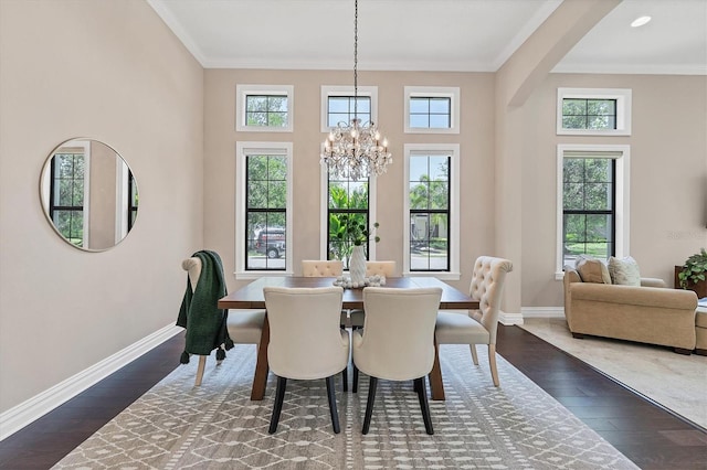 dining space featuring dark hardwood / wood-style floors, ornamental molding, and plenty of natural light