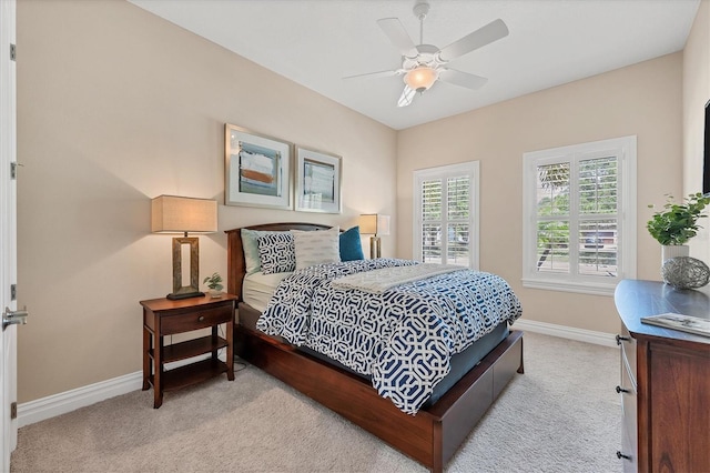 bedroom with ceiling fan and light carpet