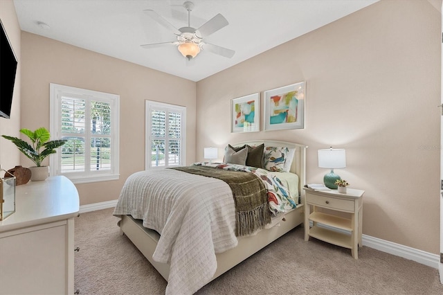 bedroom with ceiling fan and light carpet