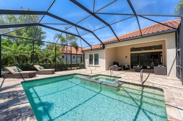 view of swimming pool with glass enclosure, a patio area, ceiling fan, and an in ground hot tub