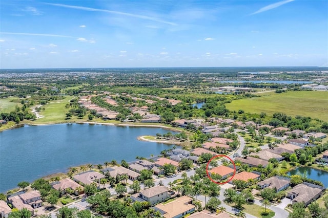 birds eye view of property with a water view