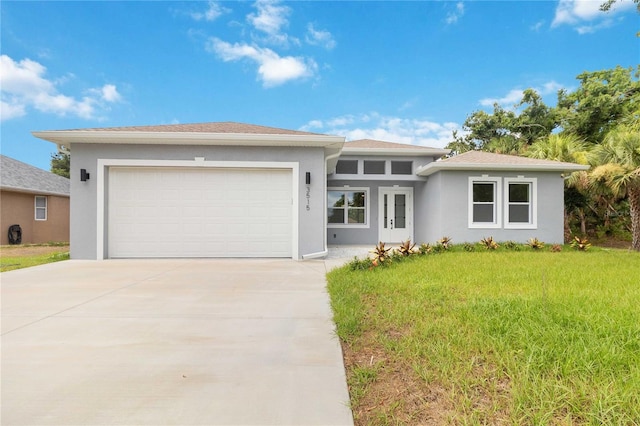 view of front of house featuring a garage and a front lawn