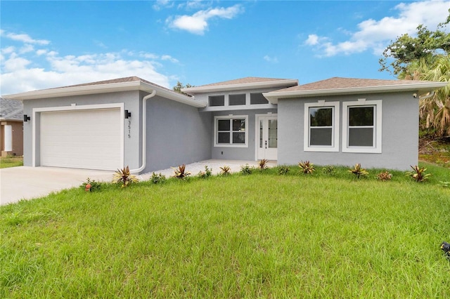 prairie-style home featuring a garage and a front yard