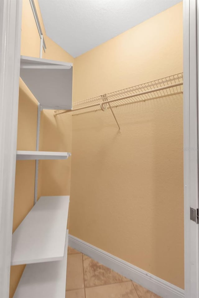 spacious closet with tile patterned floors