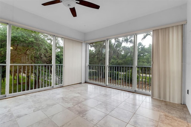 unfurnished sunroom with ceiling fan