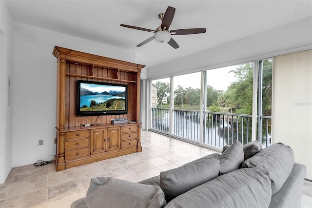 living room with ceiling fan and plenty of natural light