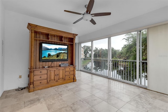 unfurnished living room featuring ceiling fan