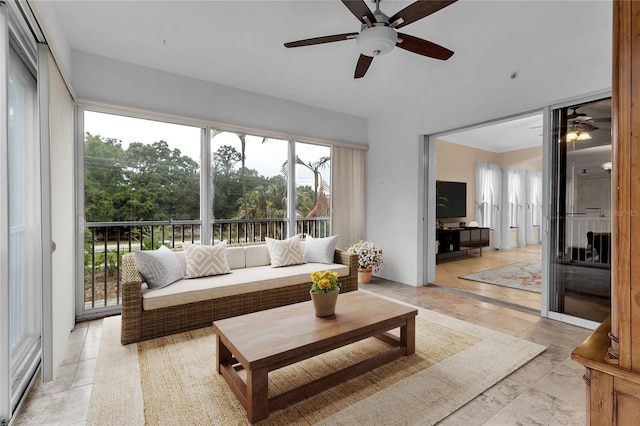 sunroom / solarium featuring ceiling fan