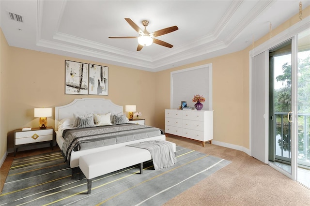 bedroom featuring ceiling fan, dark carpet, access to outside, and a tray ceiling