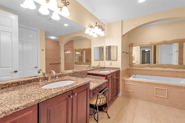 bathroom featuring tile patterned flooring, vanity, and separate shower and tub