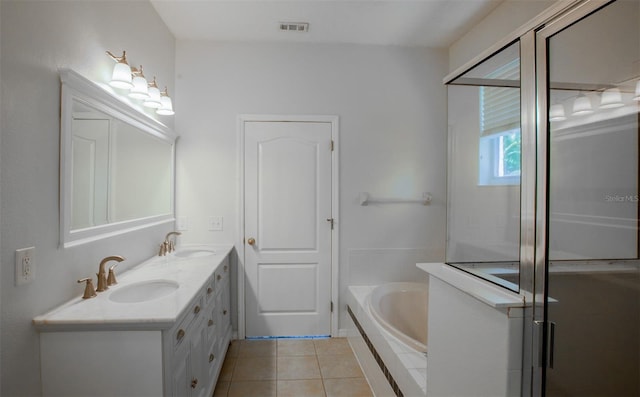 full bathroom with visible vents, a sink, a bath, and tile patterned floors