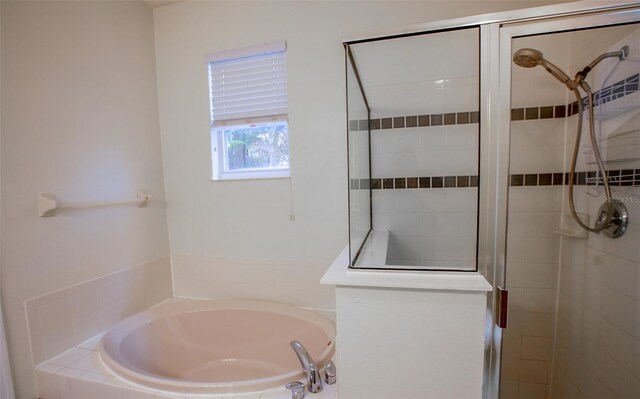 full bath with a stall shower and a garden tub