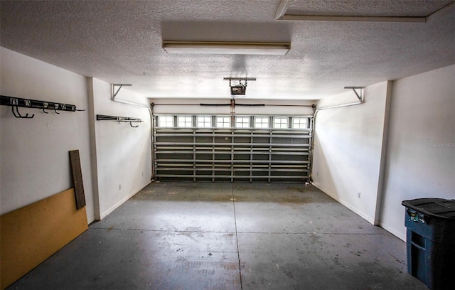 garage featuring a garage door opener and baseboards