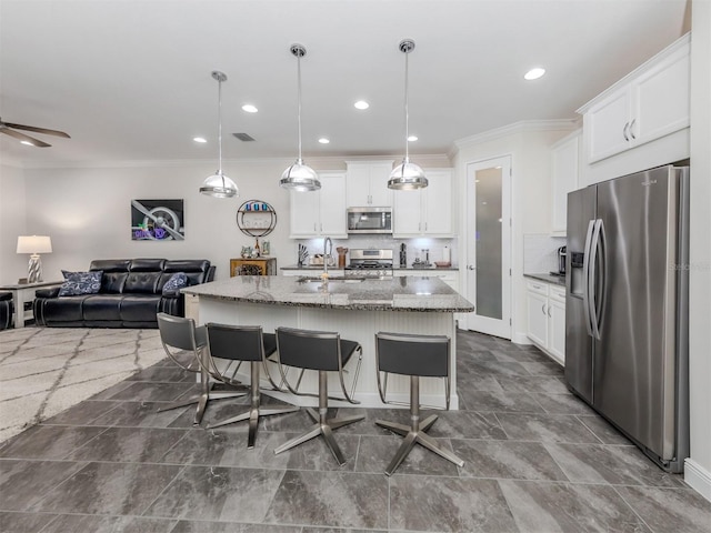 kitchen with white cabinetry, a center island with sink, and appliances with stainless steel finishes