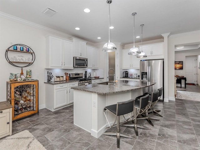 kitchen featuring white cabinetry, appliances with stainless steel finishes, sink, and a center island with sink