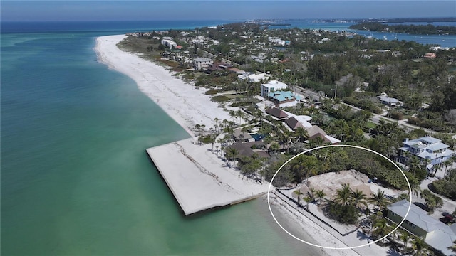 aerial view featuring a water view and a beach view