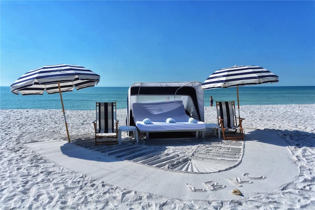 exterior space with a water view and a view of the beach