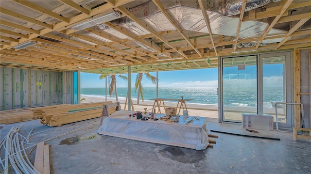 interior space with a water view and a view of the beach