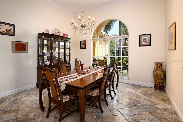 tiled dining area featuring a high ceiling, a notable chandelier, and ornamental molding