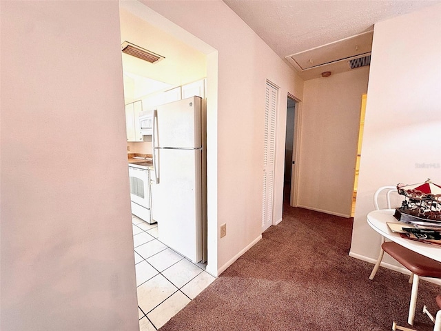 hall featuring light tile floors